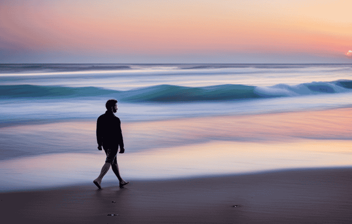 An image of a serene beach at sunset, with a lone figure walking along the shoreline, a gentle breeze rustling their hair