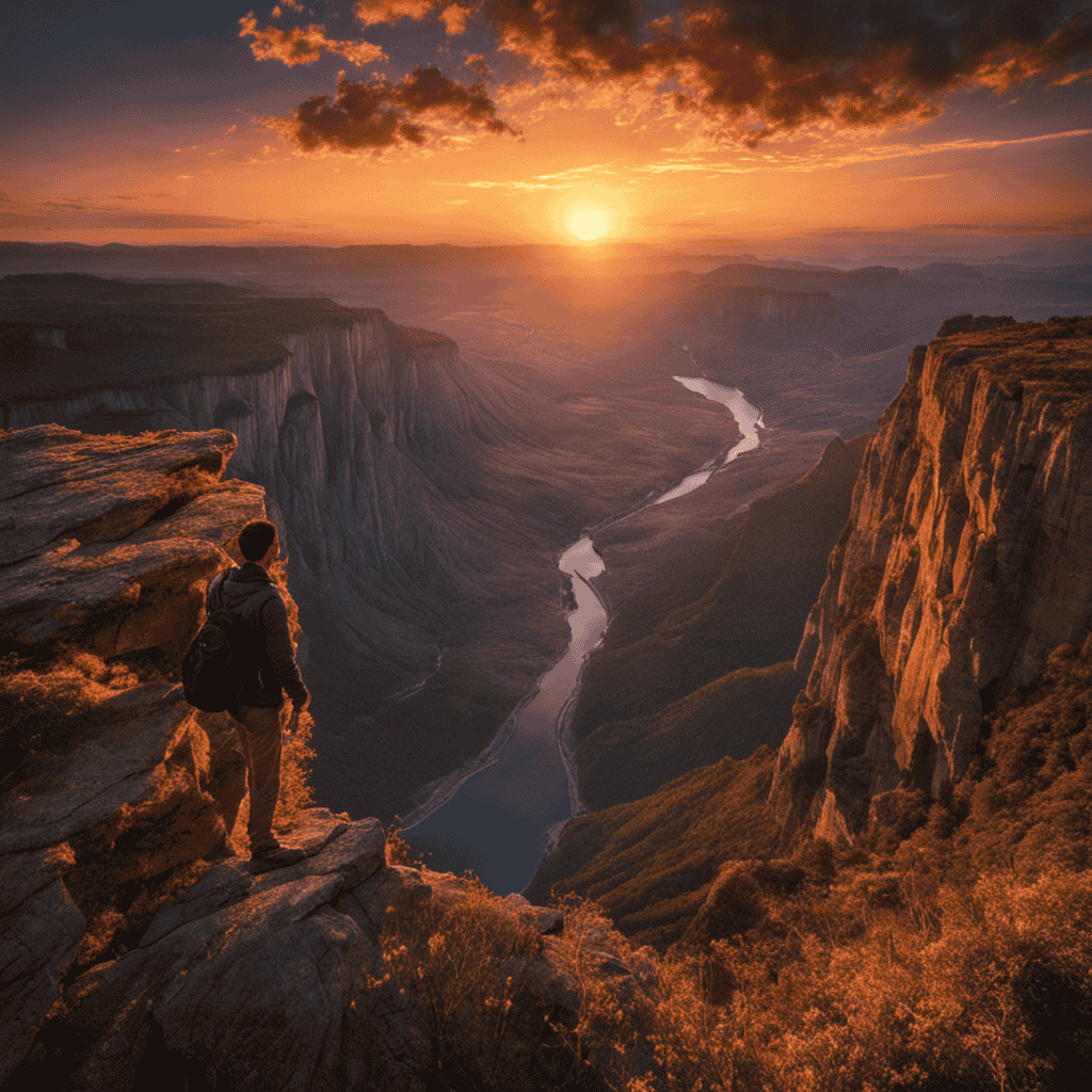 An image of a person standing at the edge of a cliff, gazing at a breathtaking sunset